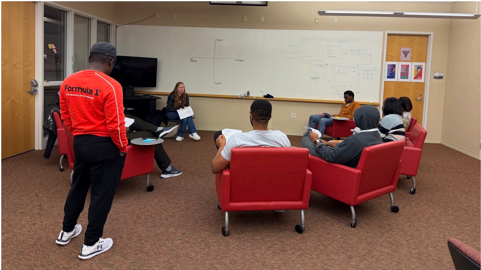 Nine Ball State students sitting in a circle during the team's brainstorming and ideation session.