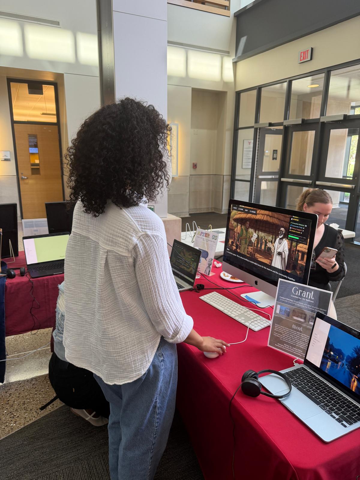 A visitor playing Wild Life Conservation on an iMac at the EMDD showcase
